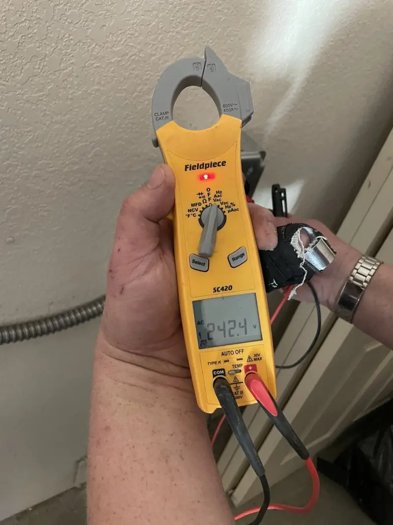 Voltage testing with clamp meter during Electrical Installation Services in Volo